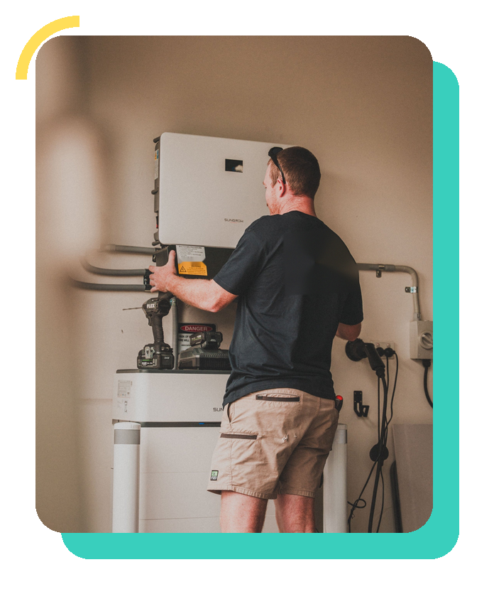 Engineer working on a wall-mounted inverter, in a Solar Heaven teal frame